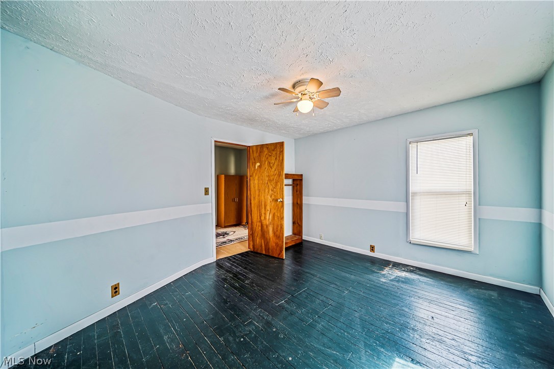116 South Cedar Street Geneva, OH 44041 - Photo 21 of 35 Bedroom with a textured ceiling, ceiling fan, and hardwood / wood-style flooring