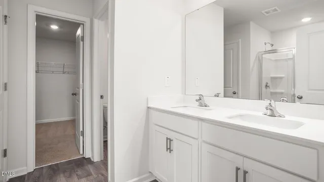 a bathroom with a double vanity sink mirror and double