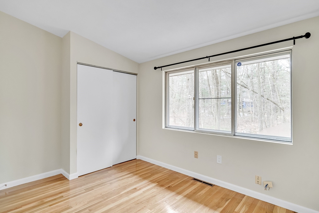 22 Partridge Road Lexington, MA 02420 - Photo 24 of 42 a view of an empty room with wooden floor and a window