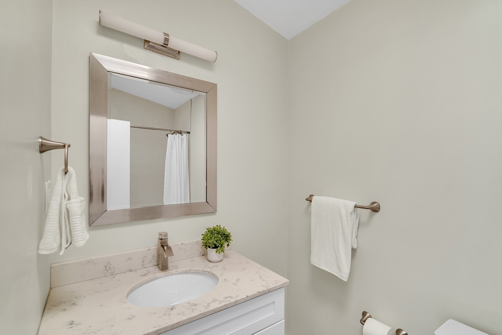 22 Partridge Road Lexington, MA 02420 - Photo 25 of 42 a bathroom with a granite countertop sink and a mirror
