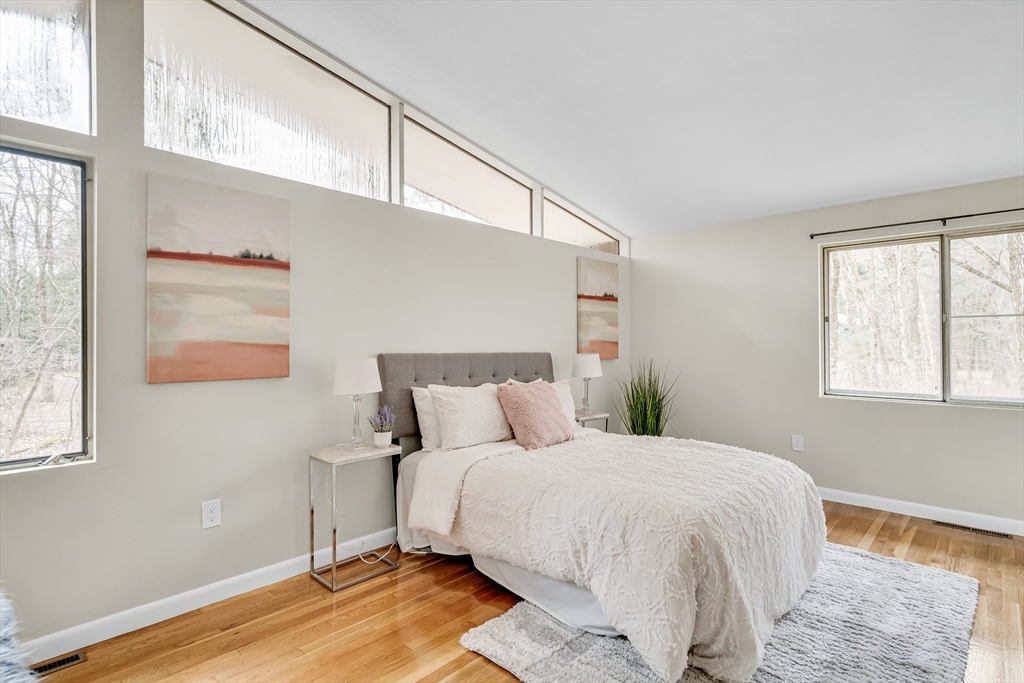 22 Partridge Road Lexington, MA 02420 - Photo 26 of 42 a large bed sitting in a bedroom next to a window