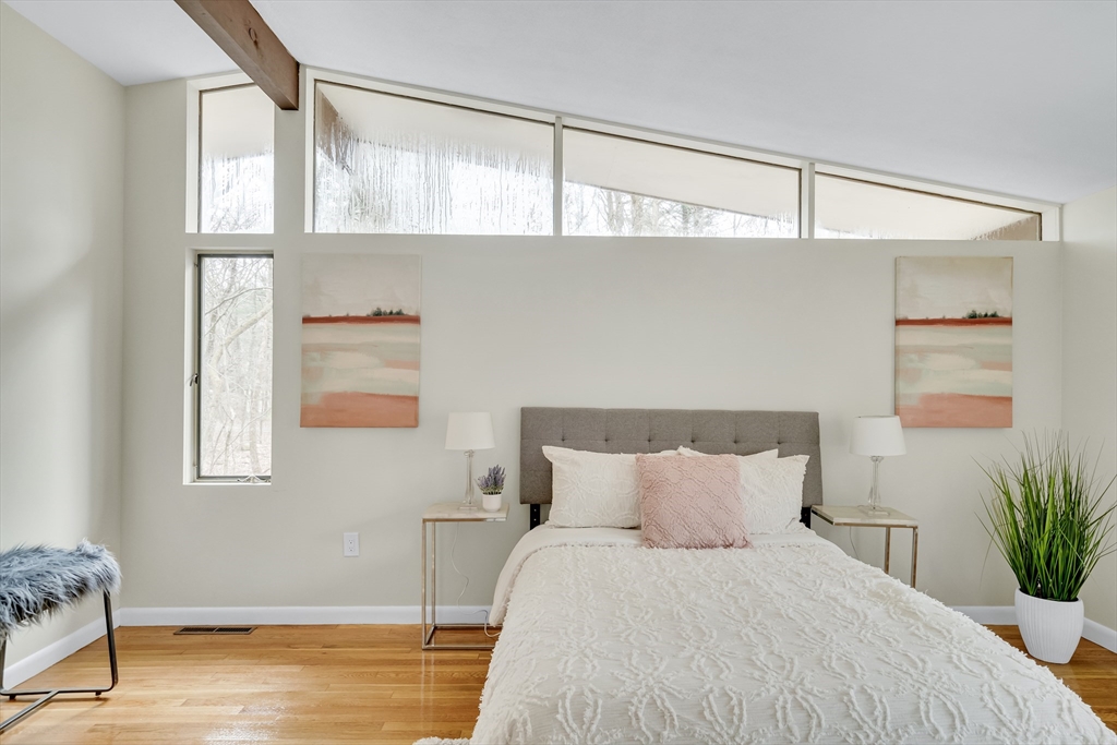 22 Partridge Road Lexington, MA 02420 - Photo 27 of 42 a large bed sitting in a bedroom next to a window