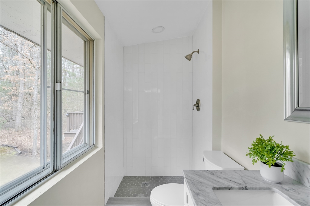 22 Partridge Road Lexington, MA 02420 - Photo 30 of 42 a bathroom with a granite countertop sink and a mirror