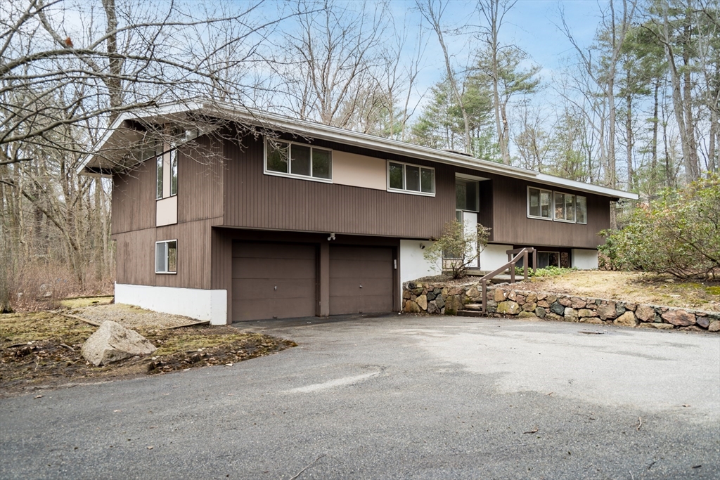 22 Partridge Road Lexington, MA 02420 - Photo 3 of 42 a front view of a house with a yard covered in snow