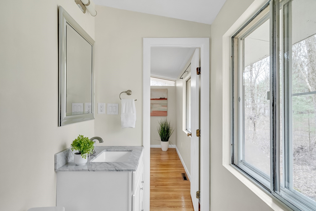 22 Partridge Road Lexington, MA 02420 - Photo 31 of 42 a hallway with sliding door and dining room view