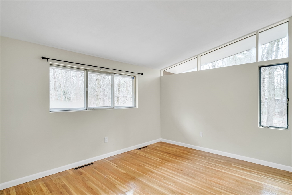22 Partridge Road Lexington, MA 02420 - Photo 32 of 42 a view of an empty room with wooden floor and a window