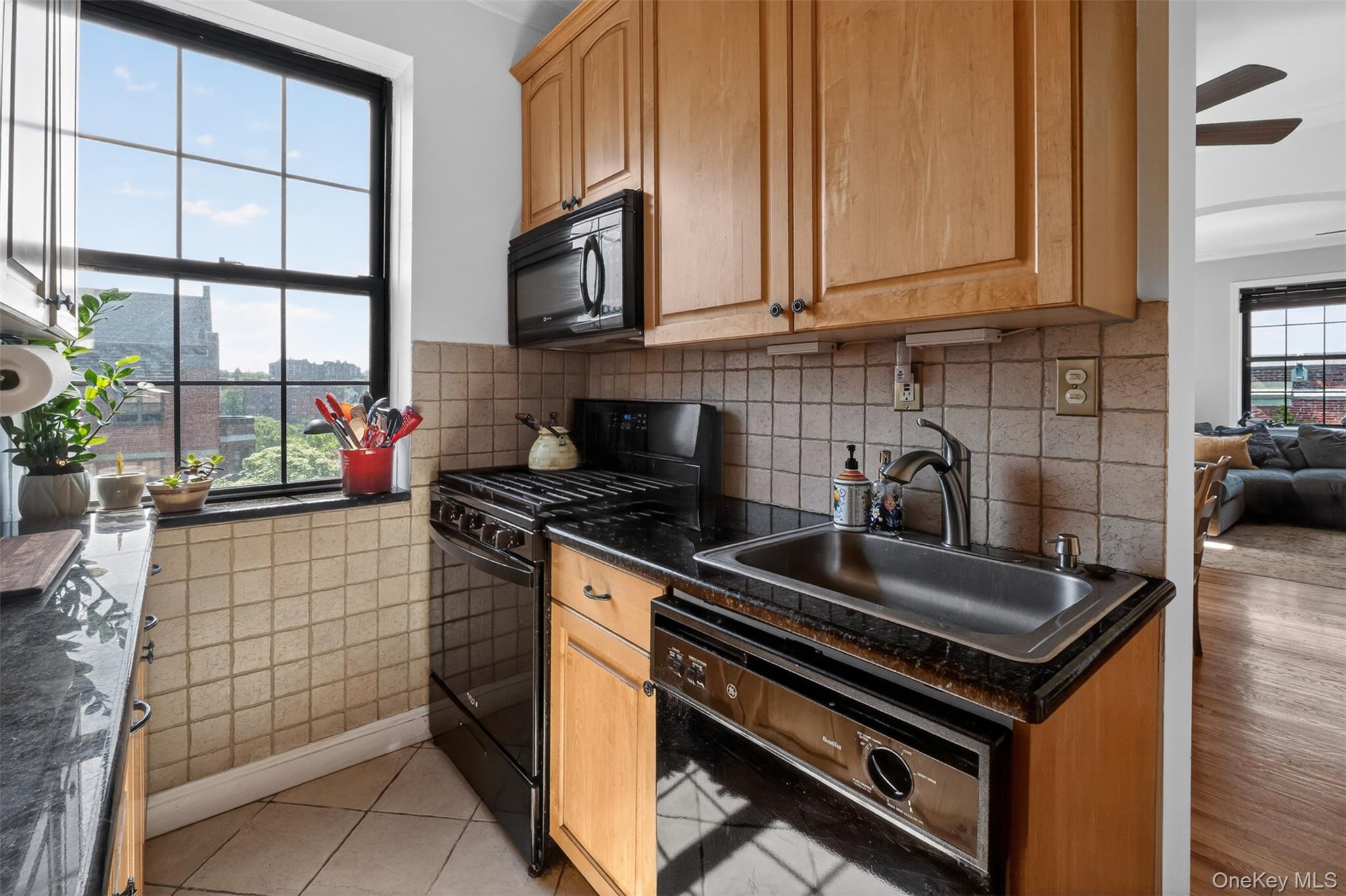 824 Bronx River Road, Unit 7C Bronxville, NY 10708 - Photo 7 of 13 a kitchen with stainless steel appliances granite countertop a sink stove and cabinets