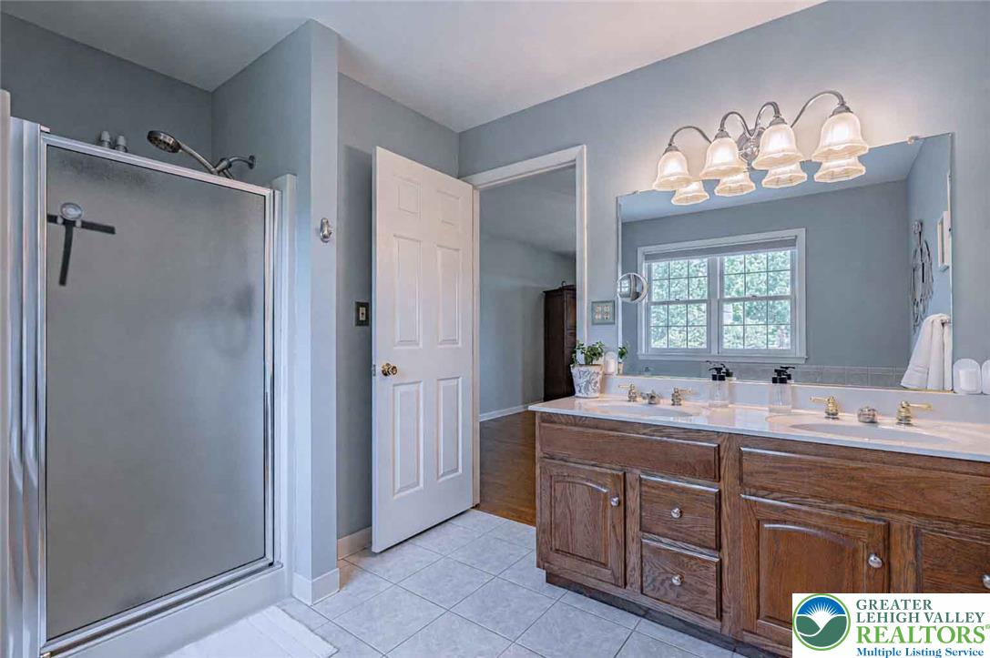 4542 Springfield Drive Coplay, PA 18037 - Photo 44 of 89 Double vanity and a spacious shower create a tranquil daily routine space.