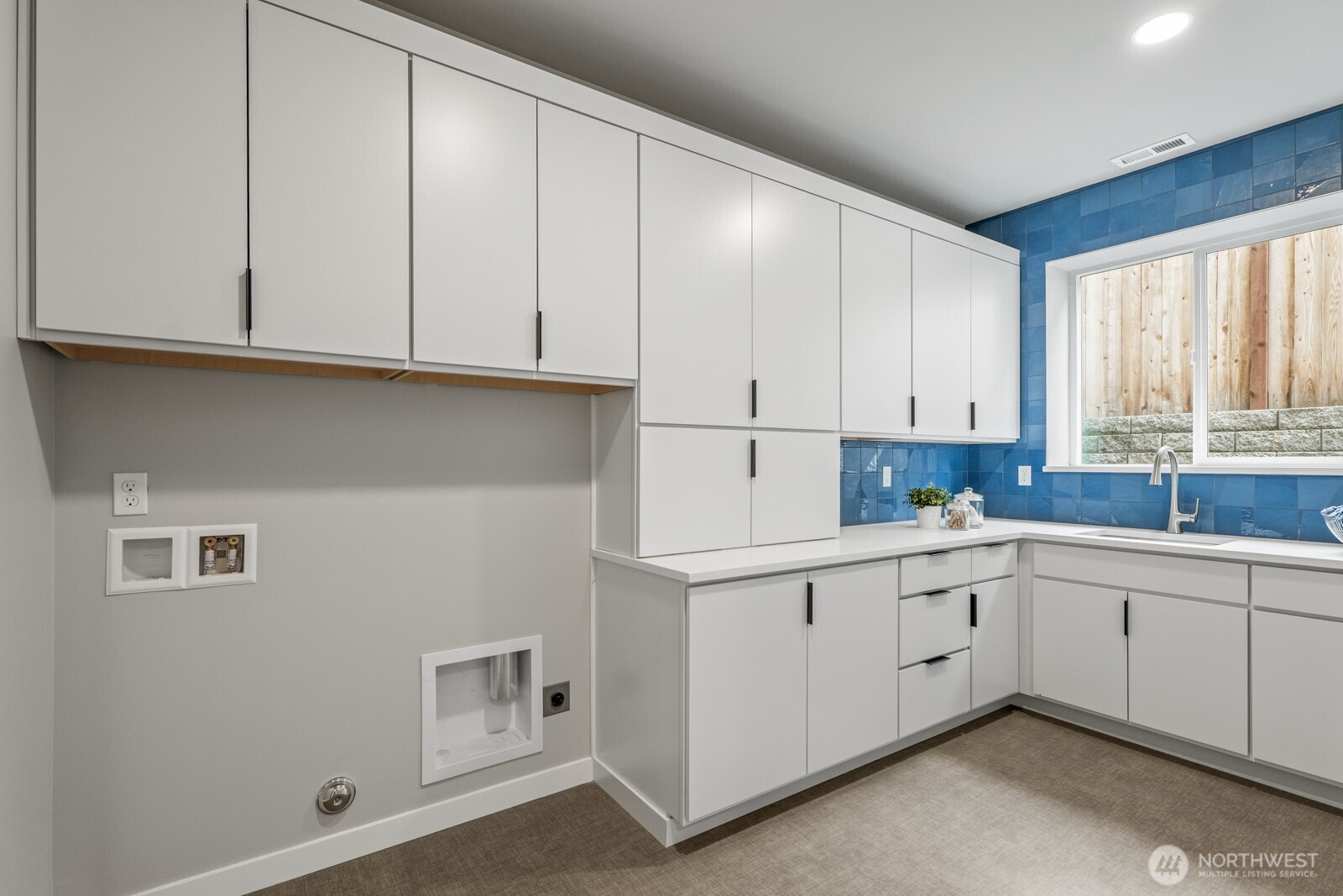 10024 Northeast 196th Place Bothell, WA 98011 - Photo 22 of 40 a kitchen with white cabinets and window