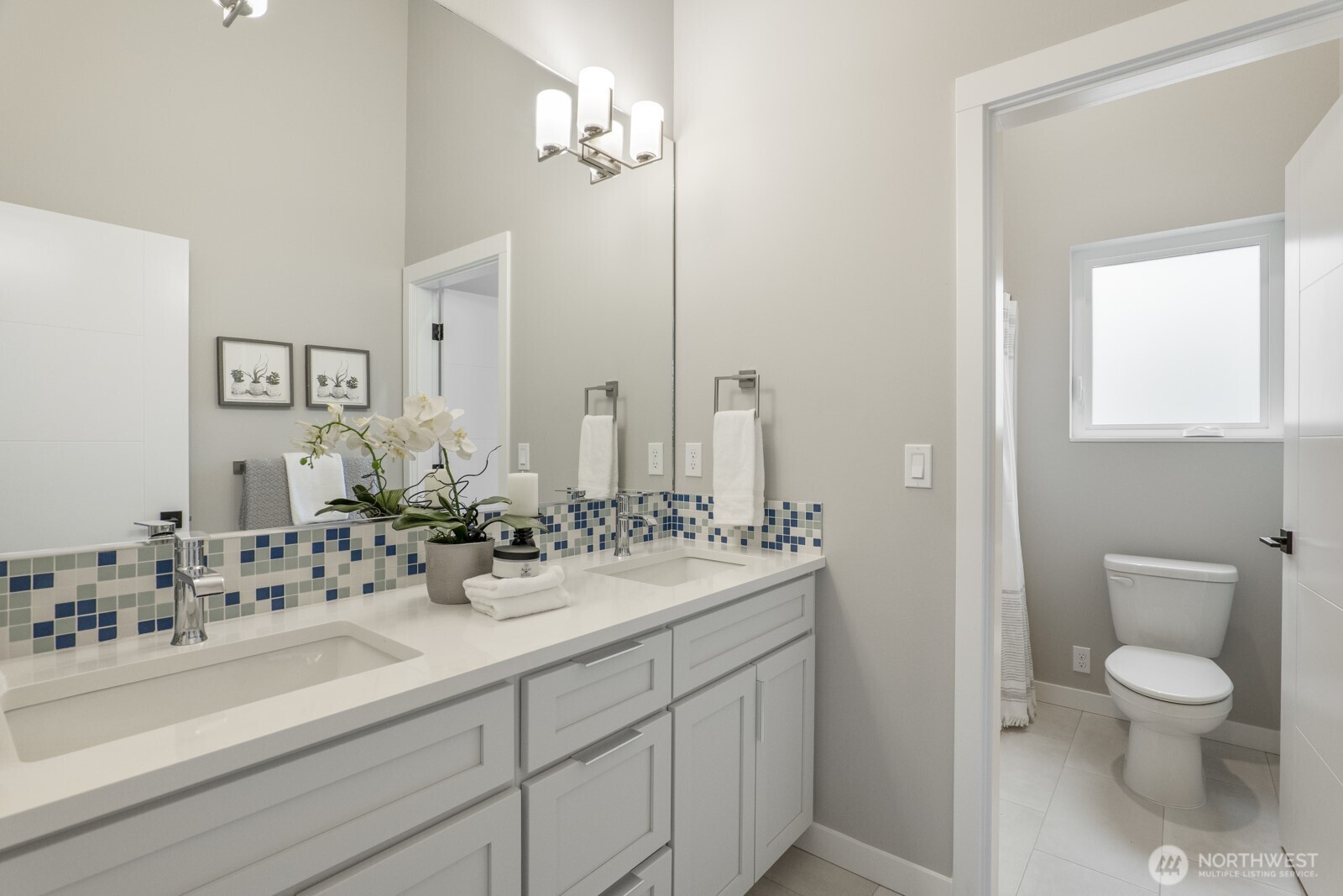 10024 Northeast 196th Place Bothell, WA 98011 - Photo 29 of 40 a bathroom with a sink a toilet and a mirror