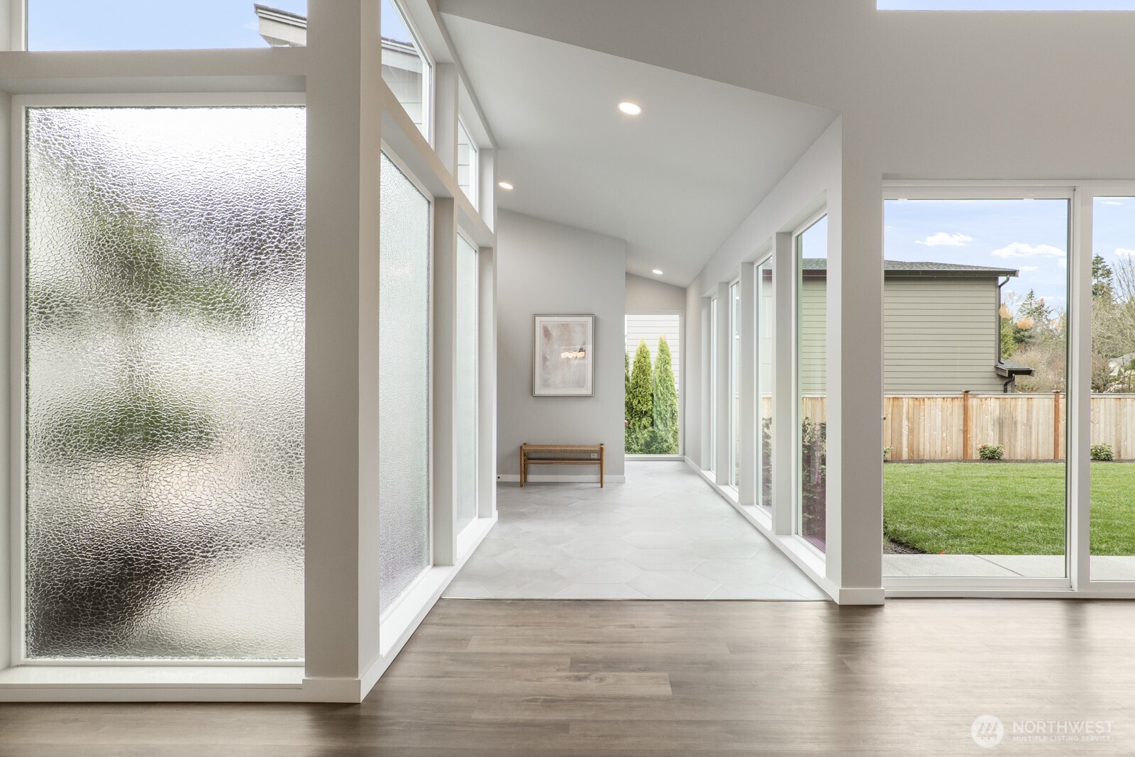10024 Northeast 196th Place Bothell, WA 98011 - Photo 32 of 40 a view of a hallway with wooden floor and a living room