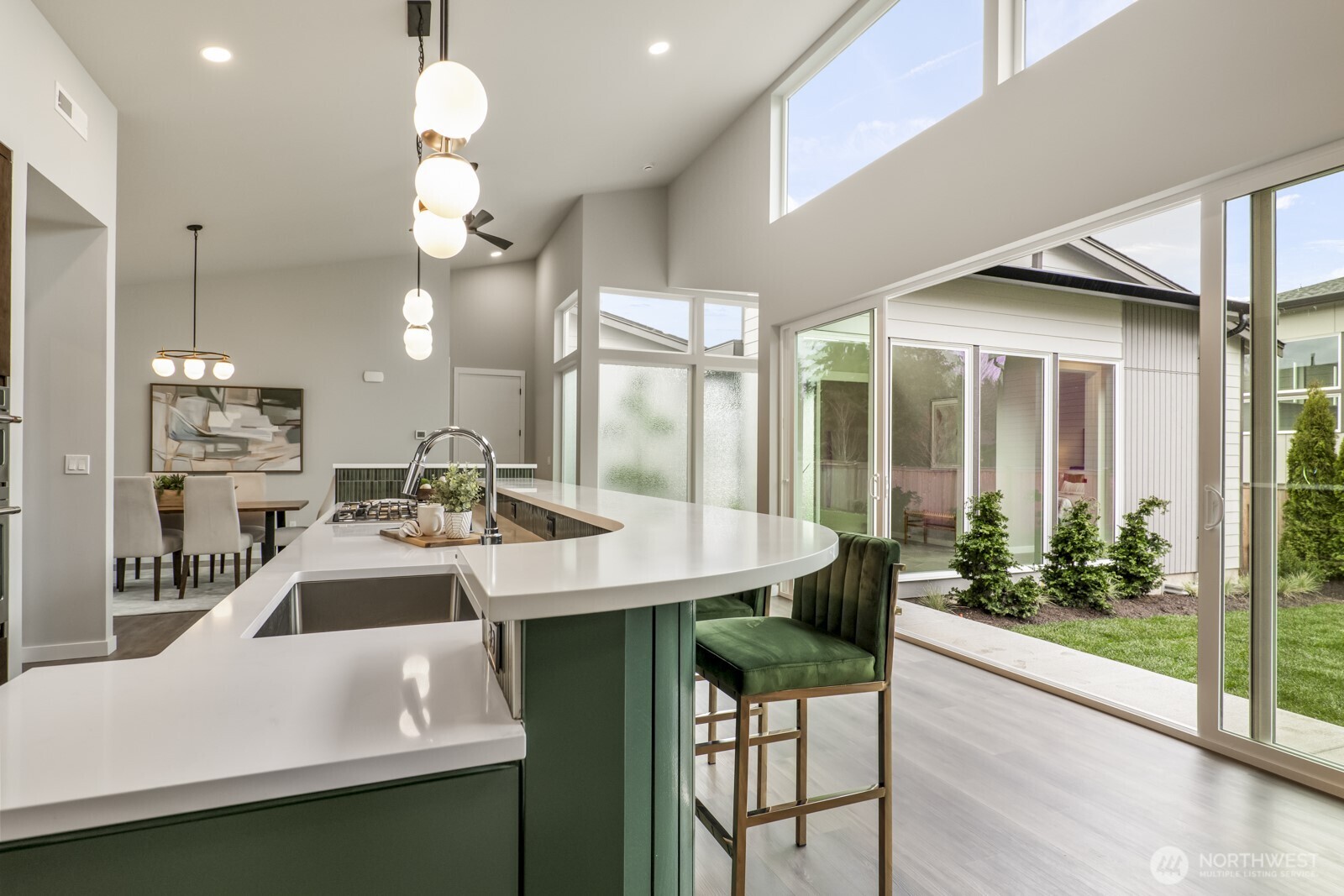 10024 Northeast 196th Place Bothell, WA 98011 - Photo 10 of 40 a kitchen with kitchen island a large window and chairs