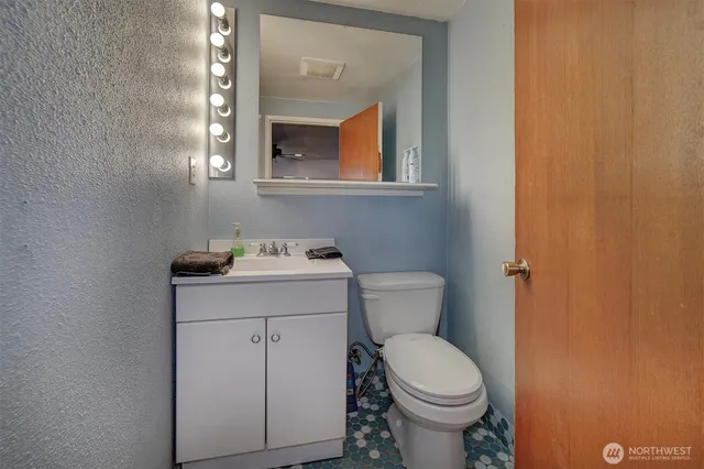 a bathroom with a toilet sink and mirror