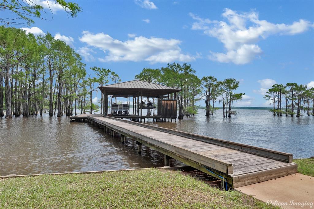649 Moore Road Elm Grove, LA 71051 - Photo 4 of 13 swimming pool view with a seating space and a garden
