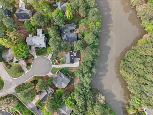 an aerial view of a house with garden space and street view