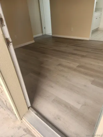a white kitchen with a sink and a stove