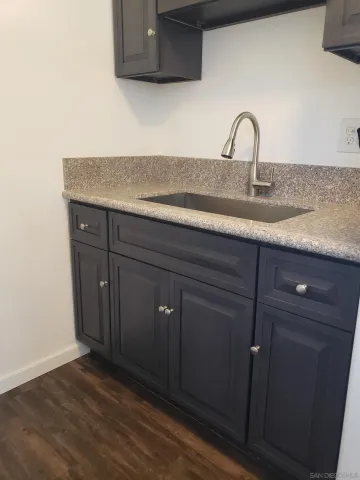 a view of a small space with wooden floor and a window