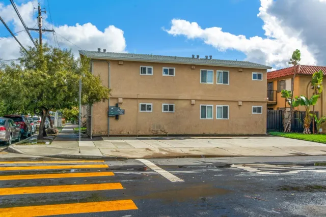 a view of street along with house and trees