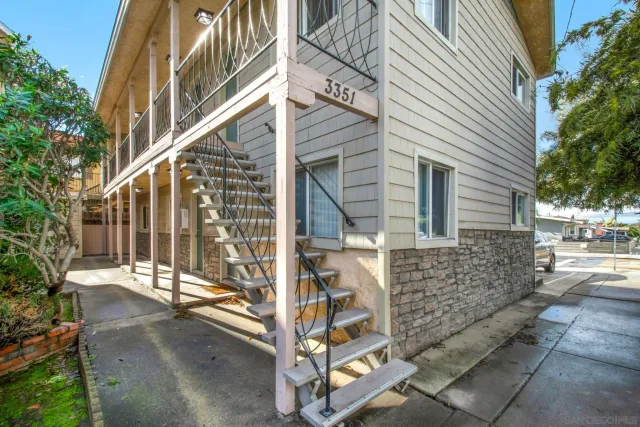 a brick building with a bench and a window
