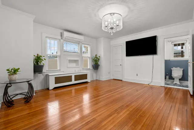 a view of a livingroom with furniture hardwood floor and a ceiling fan