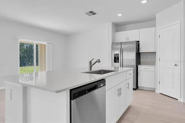 a kitchen with appliances cabinets and a sink