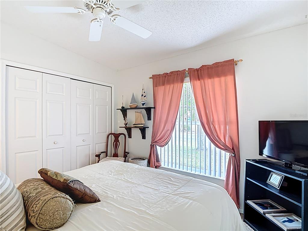 11034 Cranston Street Spring Hill, FL 34608 - Photo 19 of 40 a bedroom with a bed and a television