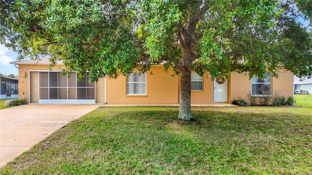 11034 Cranston Street Spring Hill, FL 34608 - Photo 2 of 40 a house view with a garden space