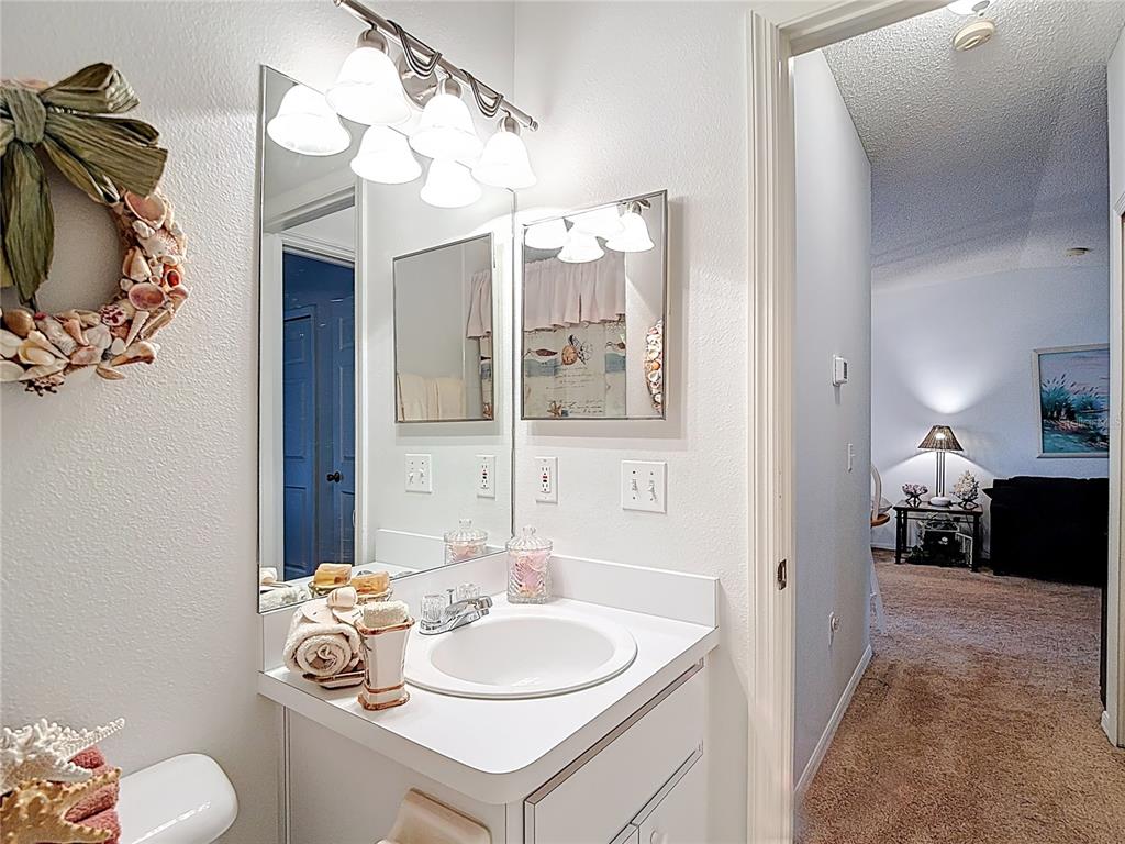 11034 Cranston Street Spring Hill, FL 34608 - Photo 23 of 40 a bathroom with a sink vanity granite and a mirror