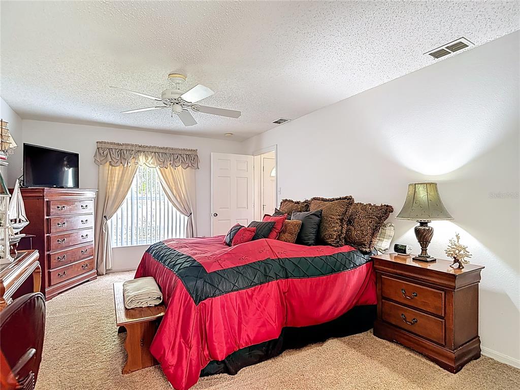 11034 Cranston Street Spring Hill, FL 34608 - Photo 25 of 40 a bedroom with a bed and a tv