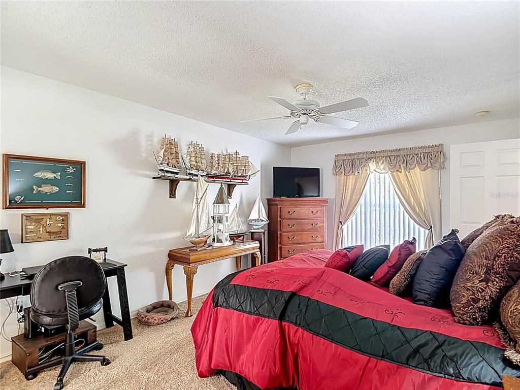 11034 Cranston Street Spring Hill, FL 34608 - Photo 26 of 40 a bedroom with a bed and a desk