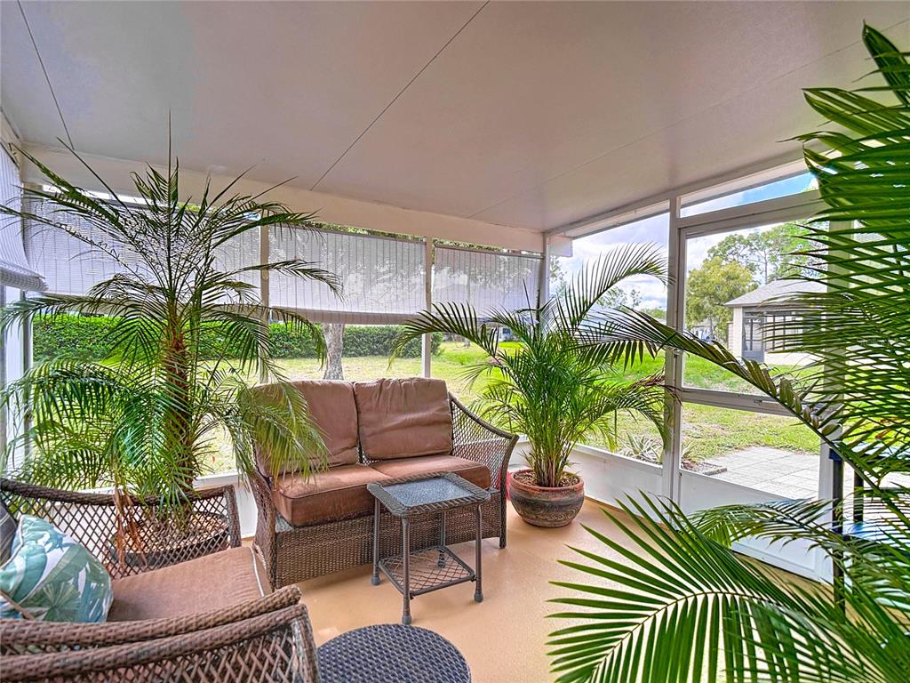 11034 Cranston Street Spring Hill, FL 34608 - Photo 32 of 40 a living room with patio furniture and a potted plant