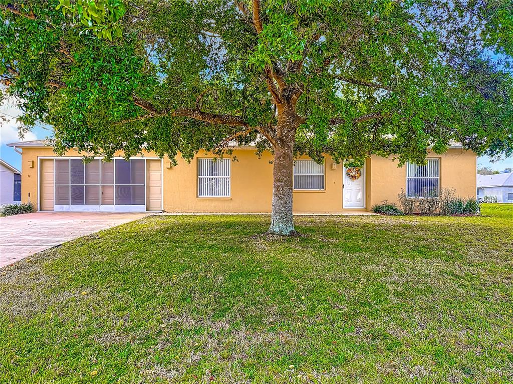 11034 Cranston Street Spring Hill, FL 34608 - Photo 4 of 40 a view of a house with a yard