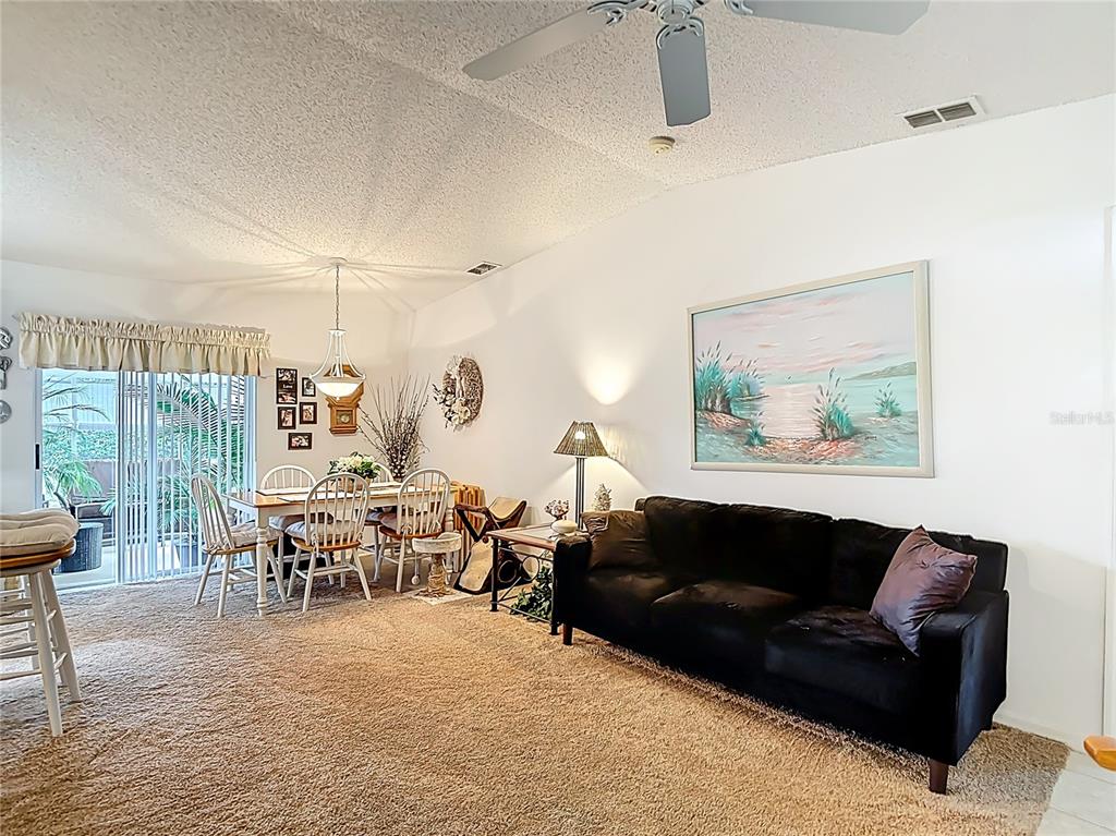 11034 Cranston Street Spring Hill, FL 34608 - Photo 7 of 40 a living room with furniture and wooden floor