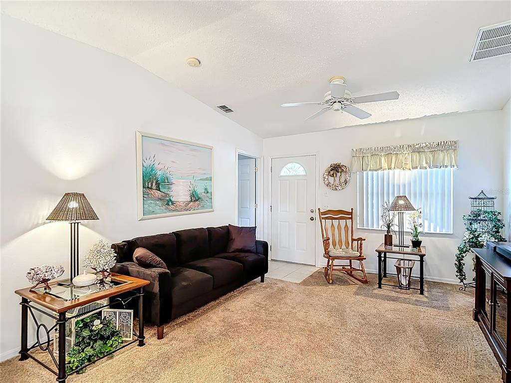 11034 Cranston Street Spring Hill, FL 34608 - Photo 8 of 40 a living room with furniture and a lamp