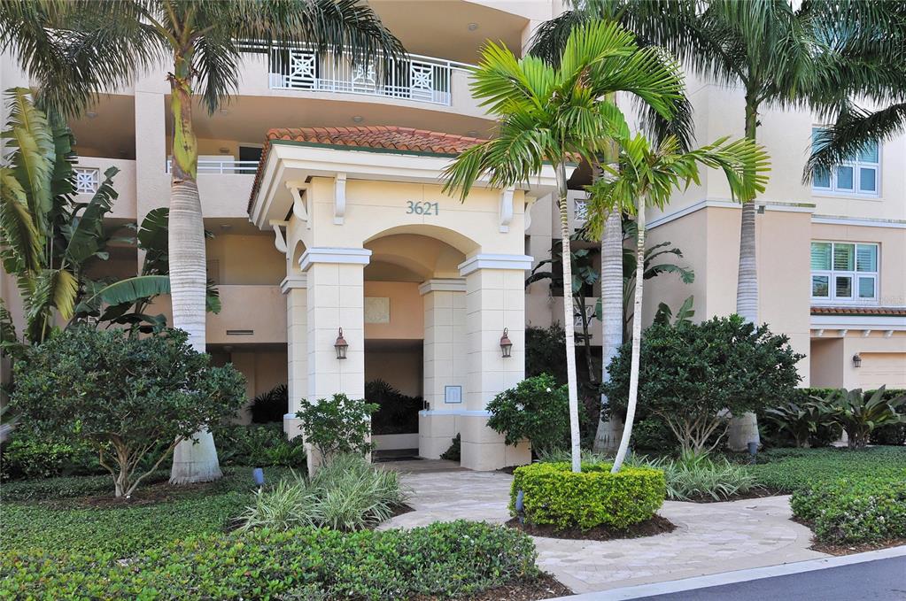 3621 North Point Road, Unit 201 Osprey, FL 34229 - Photo 1 of 1 a front view of multi story residential apartment building with yard and green space