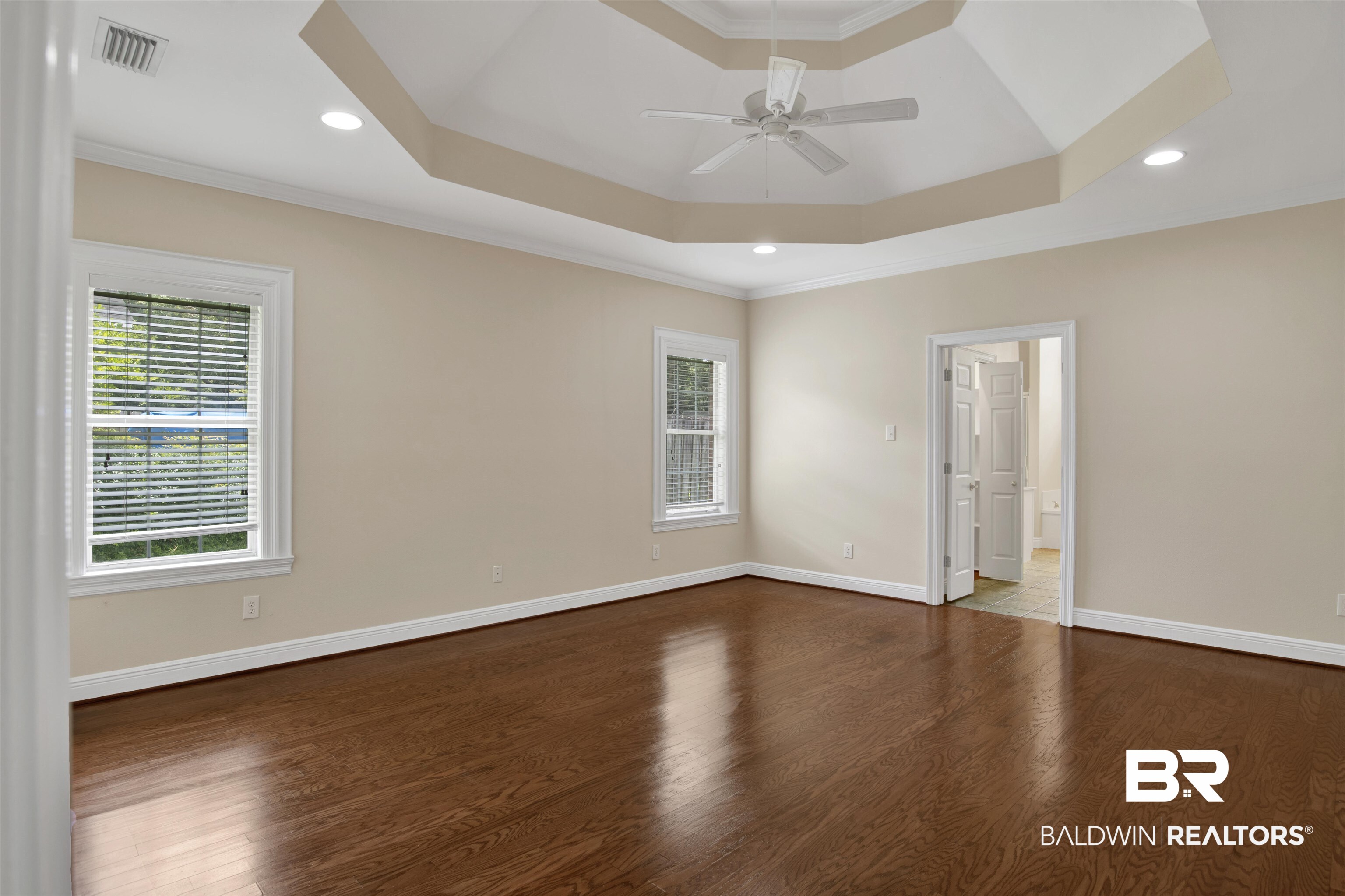 8847 Dawes Lake Road South Mobile, AL 36619 - Photo 26 of 47 Spacious room featuring rich wood-finish flooring, a tray ceiling with recessed lighting, and a ceiling fan