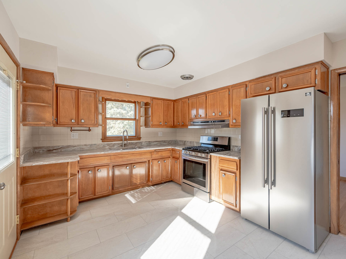 2228 High Ridge Parkway Hillside, IL 60162 - Photo 4 of 12 a large kitchen with stainless steel appliances granite countertop a refrigerator and a stove top oven