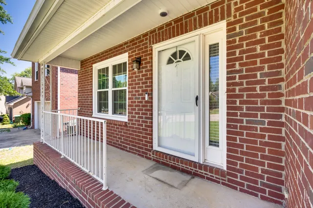 a view of front door of house with stairs