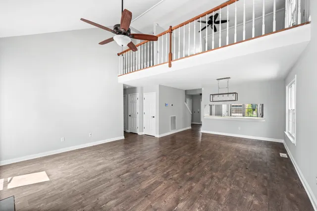 a view of a hallway with wooden floors and cabinet