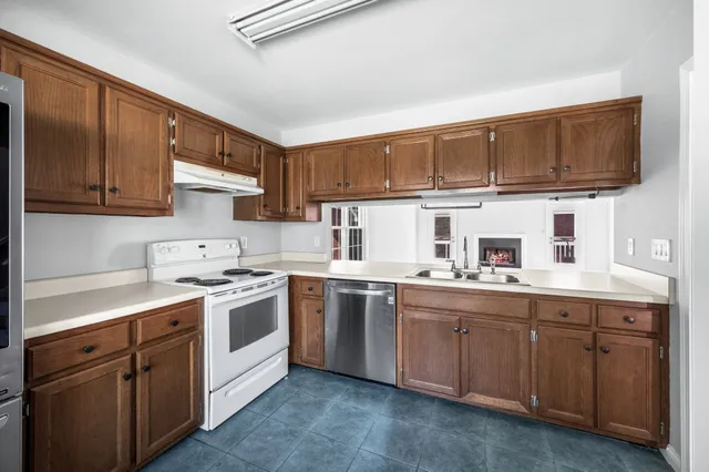 a kitchen that has a sink and a stove in it