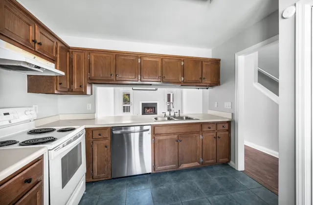 a view of a hallway with wooden floor and closet area