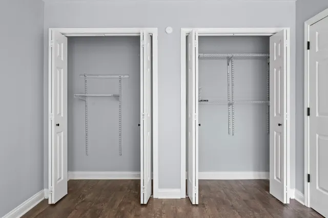 a view of a room with wooden floor and a ceiling fan