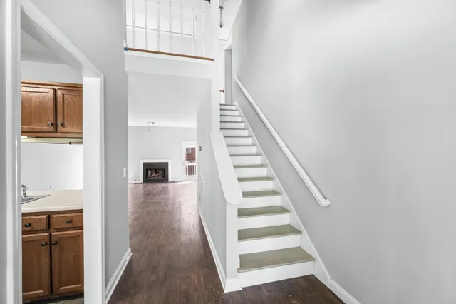 a view of a hallway with wooden floor and entryway