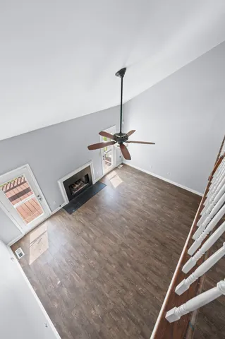 a view of an empty room with wooden floor