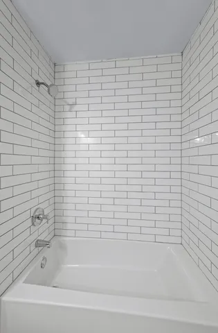 a view of a small space with wooden floor and a chandelier fan