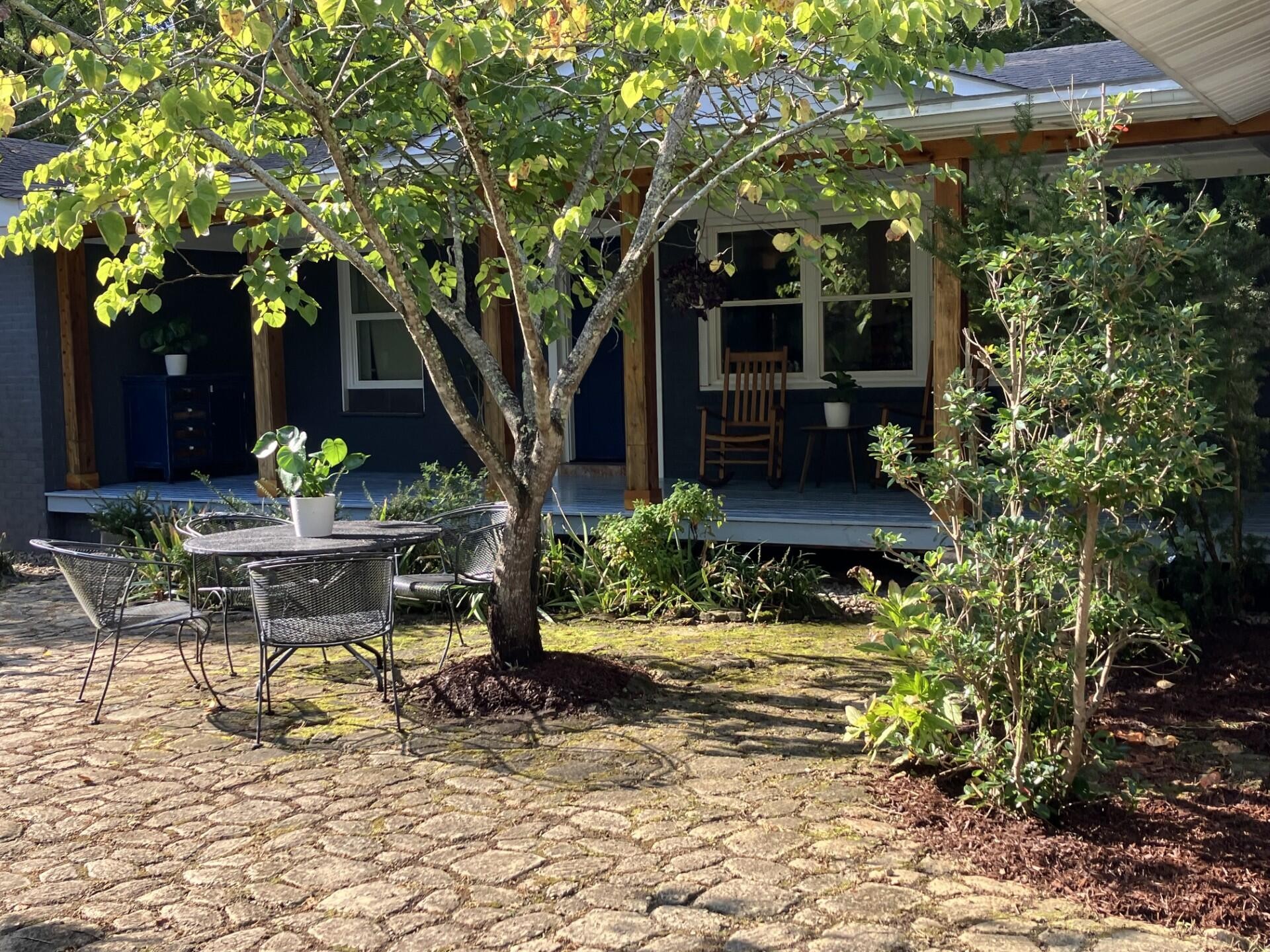 264 Ball Park Road Sewanee, TN 37375 - Photo 2 of 67 a view of a lounge chair and table in the patio