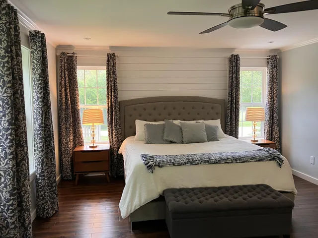 a bedroom with a bed and a lamp