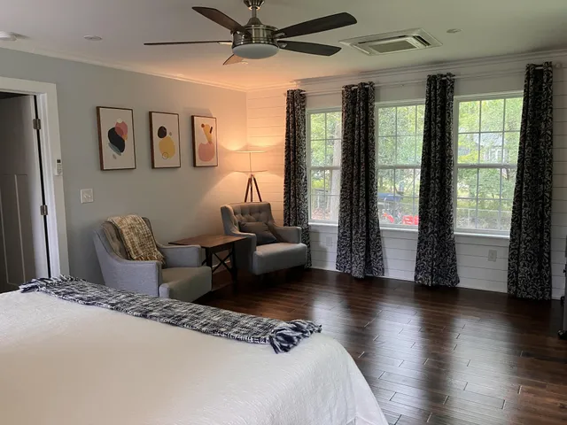 a view of a hallway with wooden floor