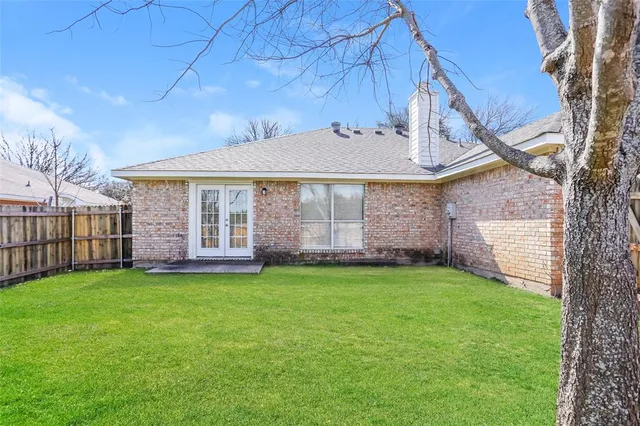 a view of a house with a yard and pathway