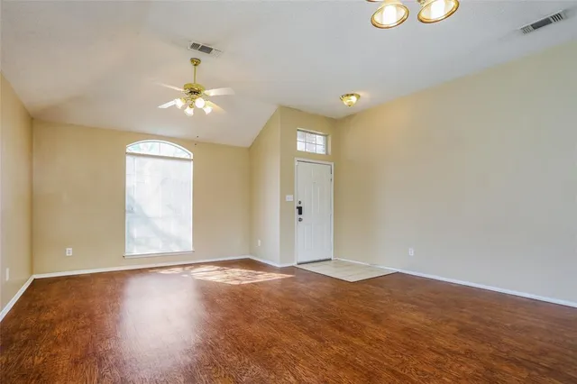 wooden floor in an empty room with a window